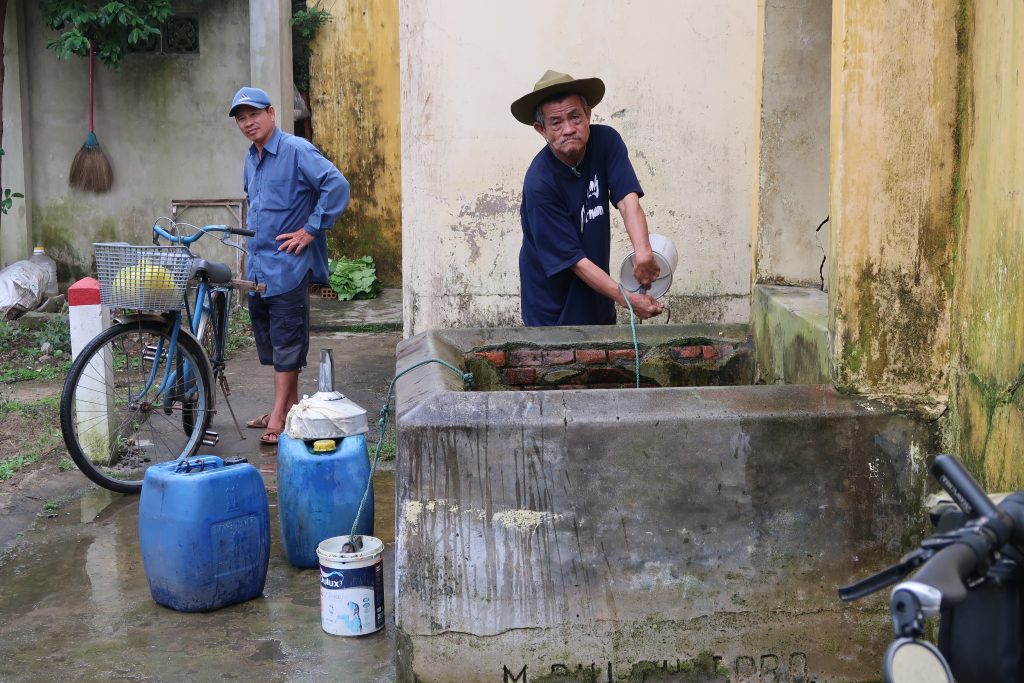 Man-collecting-water-from-well
